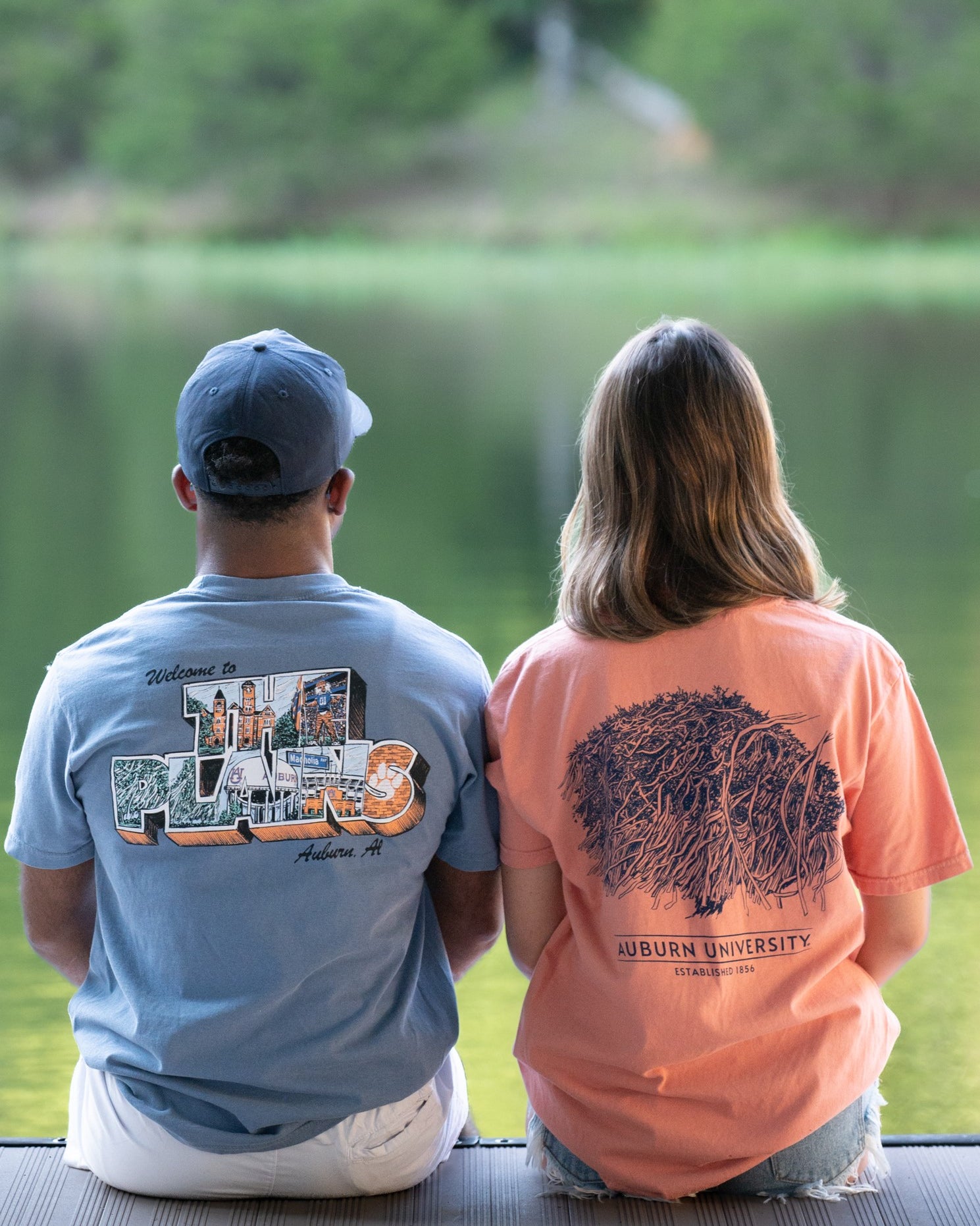 Auburn University Blue The Plains T-Shirt with postcard style text "Welcome to THE PLAINS" with "The Plains" filled with images of iconic buildings in that location