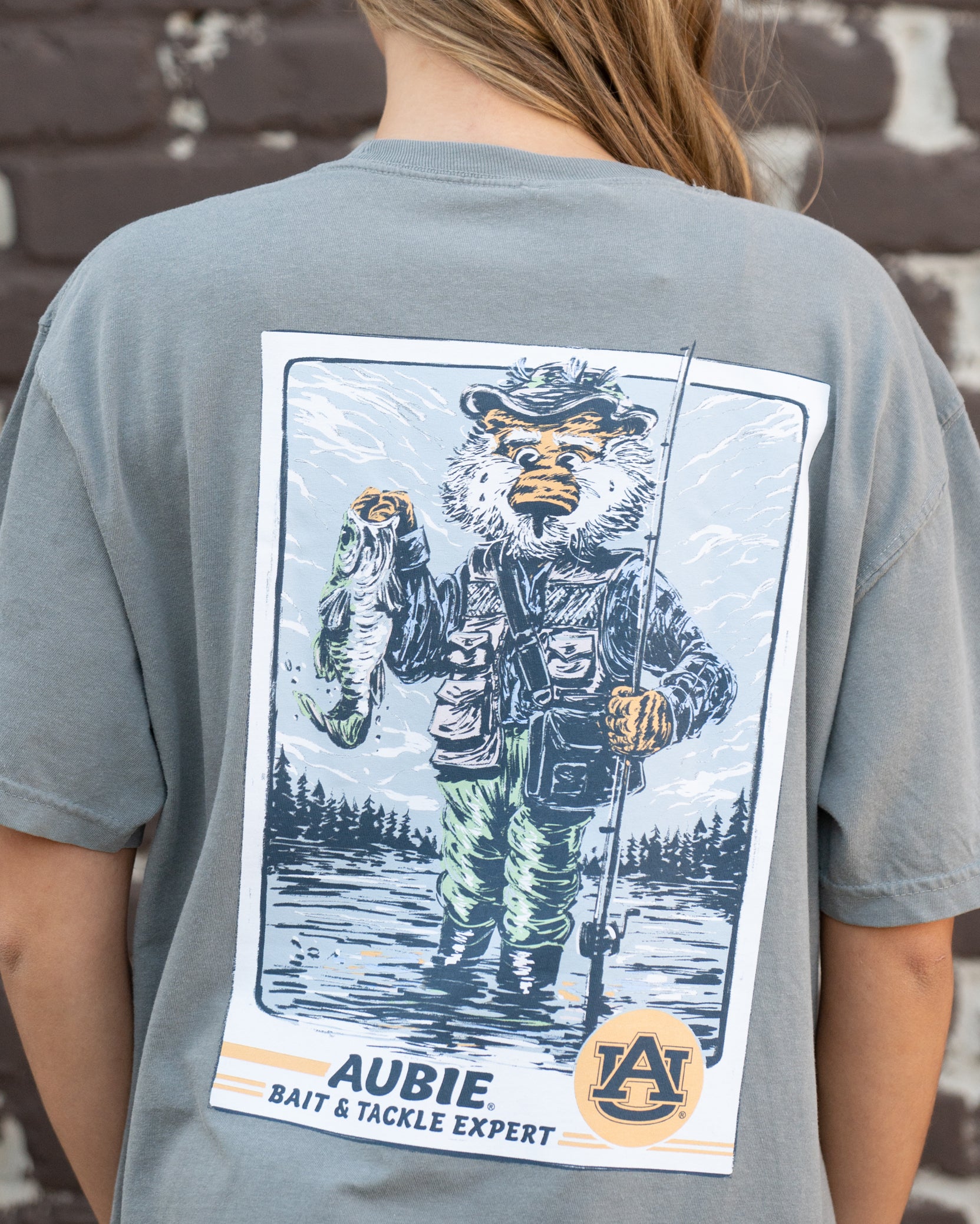 Auburn University Aubie Fishing Comfort Colors Grey T-Shirt with image of Aubie standing in the water holding a fishing pole