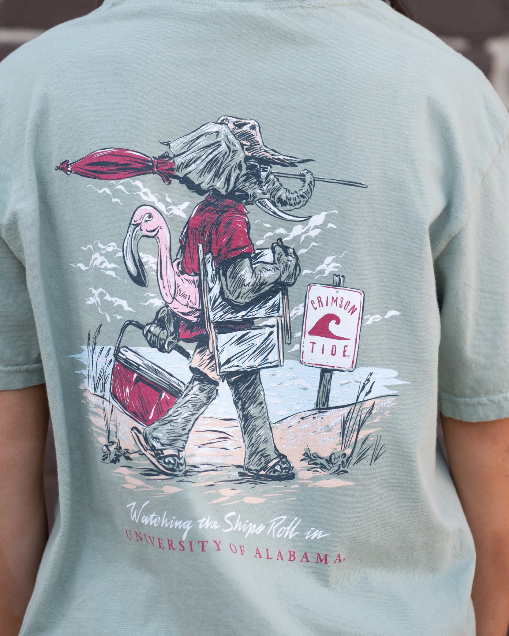 University of Alabama Big Al Beach Chalky Mint Comfort Colors T-Shirt with an image of Big Al in beach clothes carrying an umbrella dragging a cooler across the sand