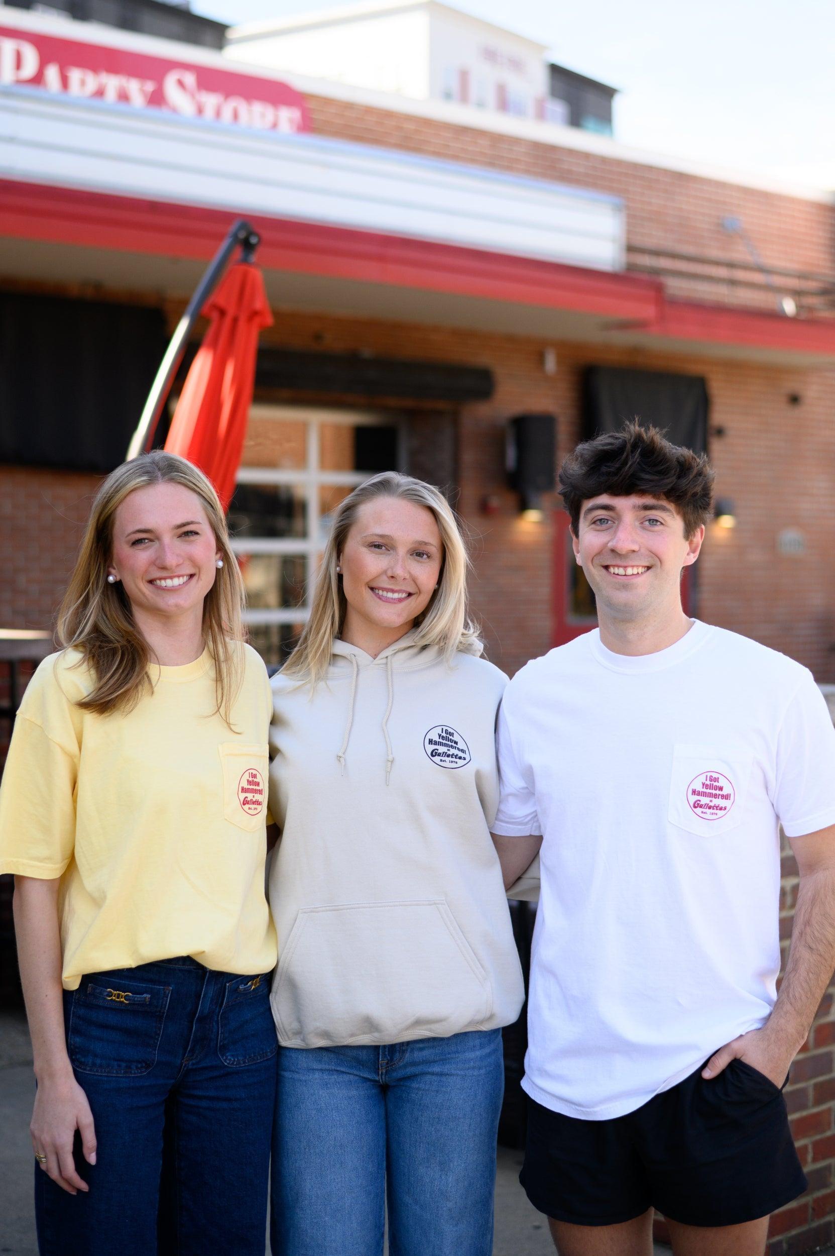 Two women and a man wearing Gallettes Yellow Hammer products