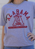 University of Alabama Grey T-Shirt with Red text “Alabama” above a Block A with an old-fashioned football player