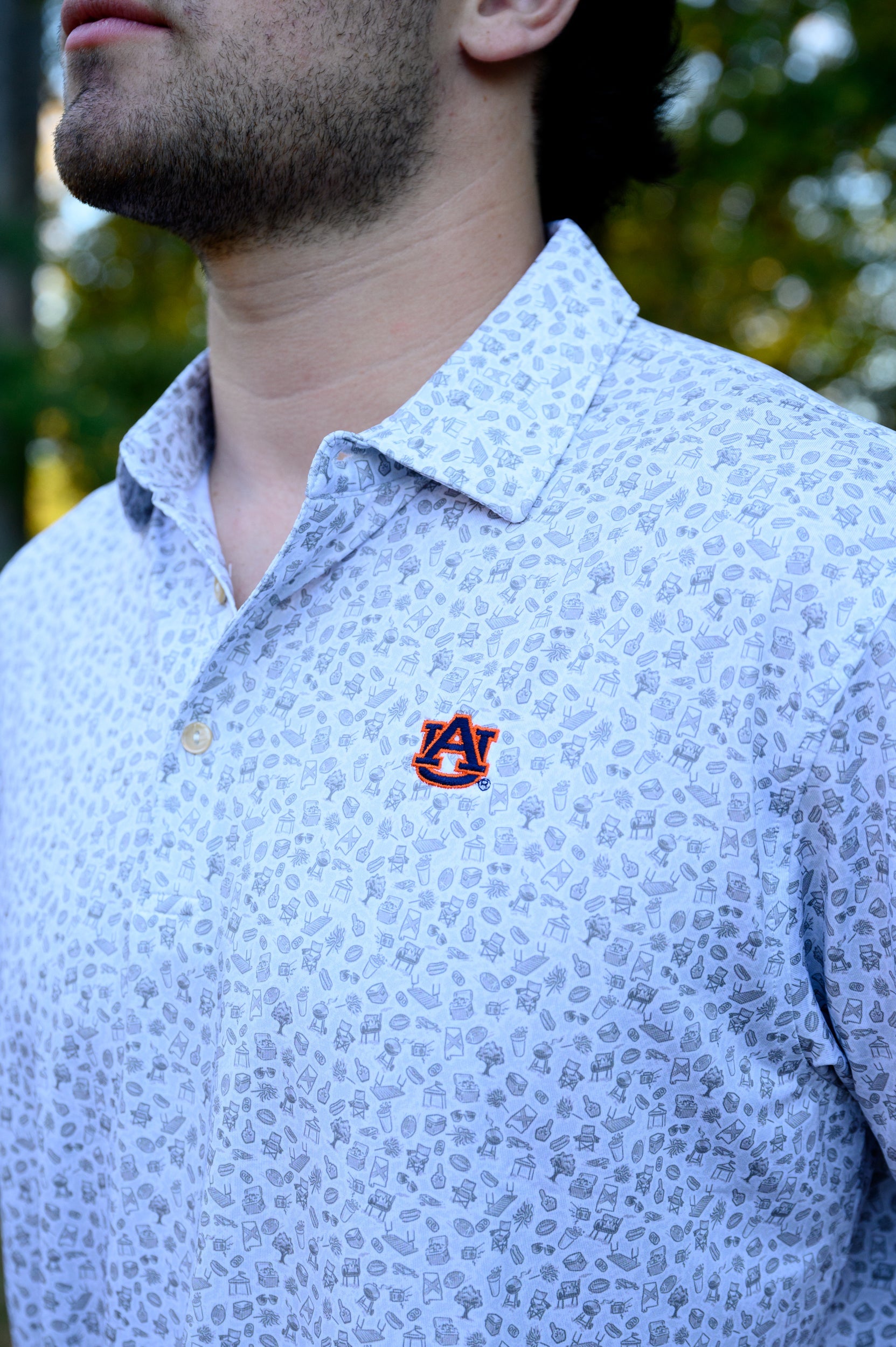 Auburn University AU Tailgate Polo (AU Logo) Grey Men's JNJ Performance Polo with a small Grey pattern of Drinks, Snacks, Grills, and Alabama states, etc.. and AU Logo Embroidery