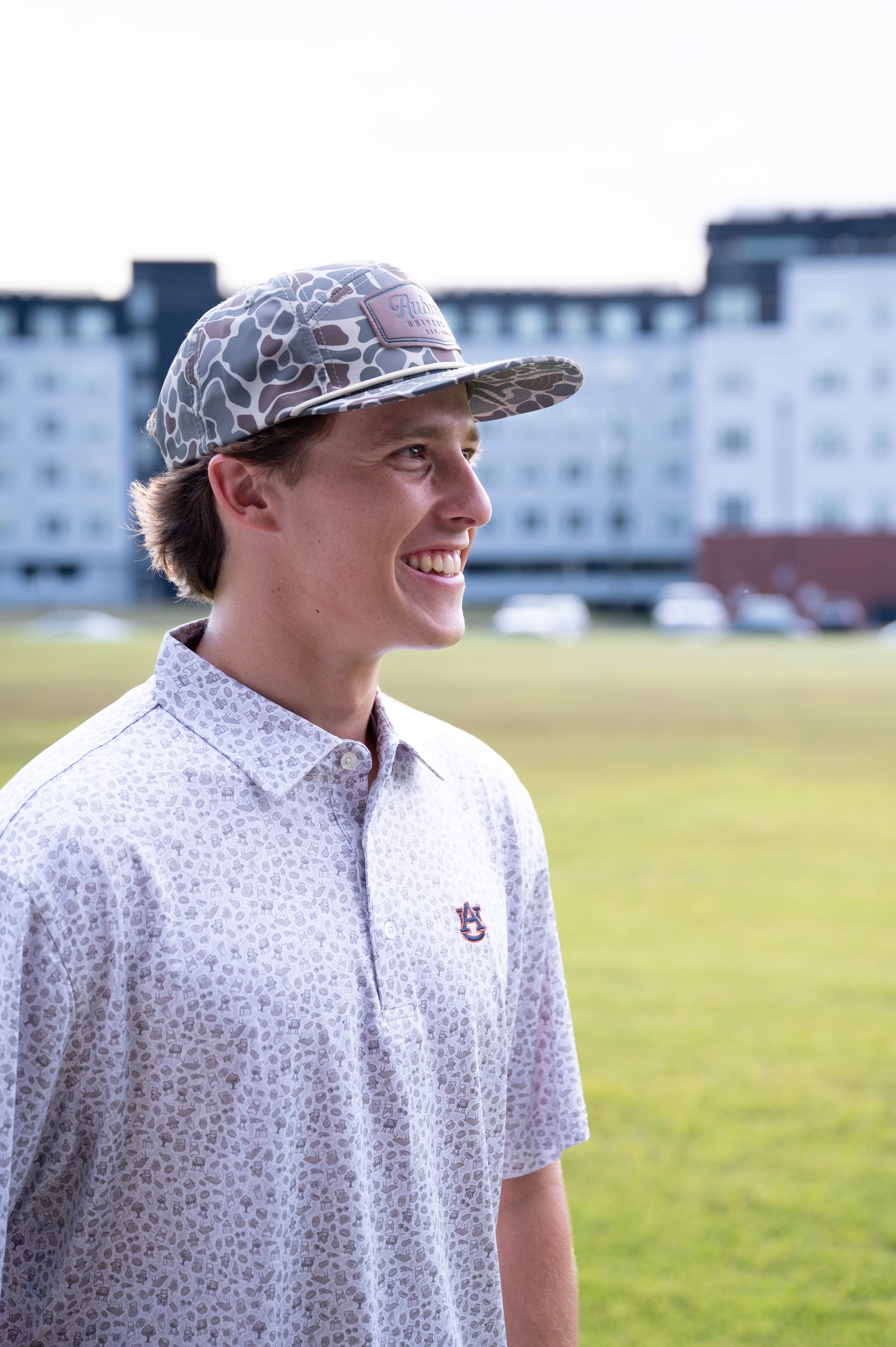 Auburn University AU Tailgate Polo (AU Logo) Grey Men's JNJ Performance Polo with a small Grey pattern of Drinks, Snacks, Grills, and Alabama states, etc.. and AU Logo Embroidery