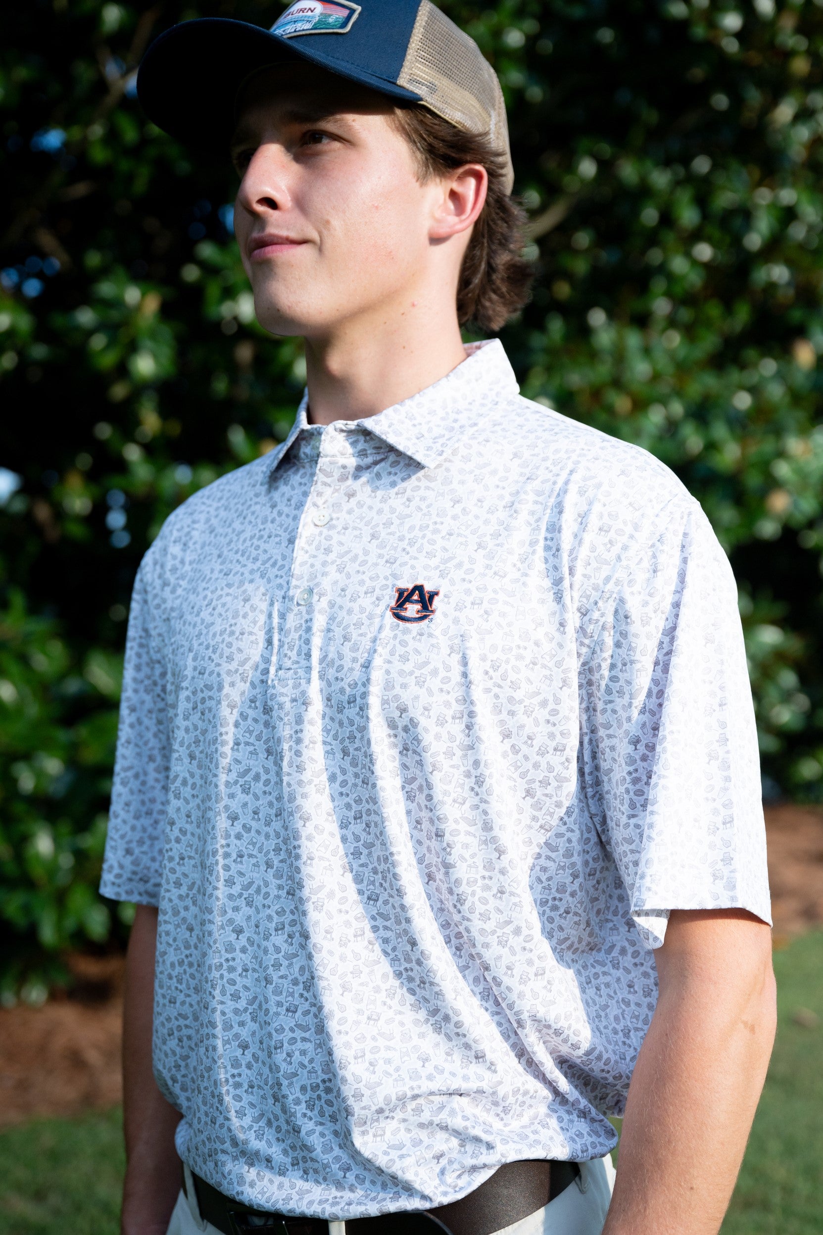 Auburn University AU Tailgate Polo (AU Logo) Grey Men's JNJ Performance Polo with a small Grey pattern of Drinks, Snacks, Grills, and Alabama states, etc.. and AU Logo Embroidery