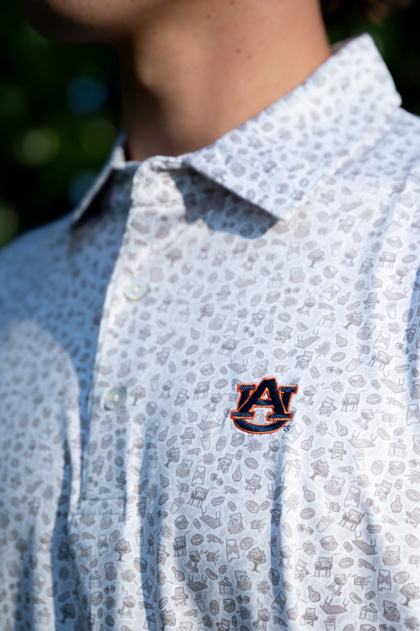 Auburn University AU Tailgate Polo (AU Logo) Grey Men's JNJ Performance Polo with a small Grey pattern of Drinks, Snacks, Grills, and Alabama states, etc.. and AU Logo Embroidery