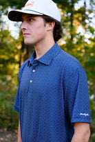 Auburn University Navy Men's Dot Polo with Light Blue and Orange dots and White "War Eagle" embroidery on the sleeve
