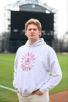 University of Alabama Distressed Light Grey Hoodie with a Red Baseball featuring the Vintage A logo over crossed baseball bats, surrounded by Red text “Alabama Baseball”
