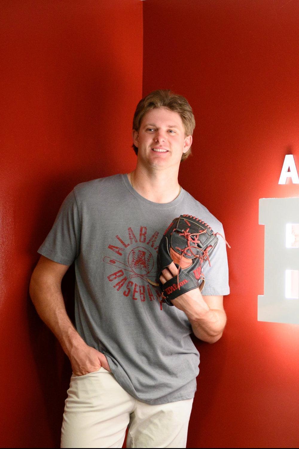 University of Alabama Distressed Grey T-Shirt with a Red Baseball featuring the Vintage A logo over crossed baseball bats, surrounded by White text “Alabama Baseball”