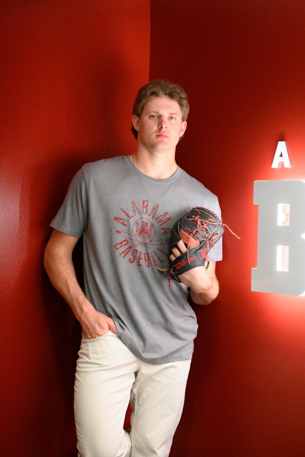 University of Alabama Distressed Grey T-Shirt with a Red Baseball featuring the Vintage A logo over crossed baseball bats, surrounded by White text “Alabama Baseball”