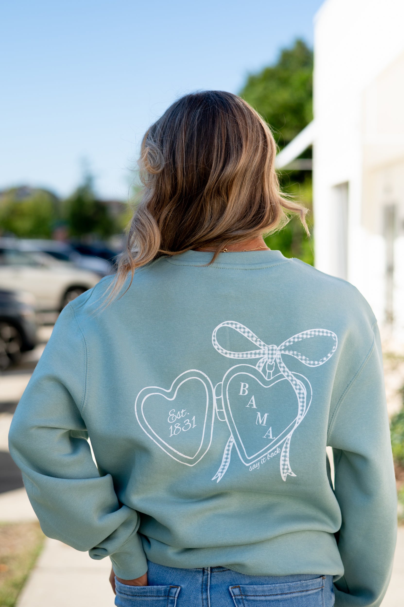 University of Alabama Seafoam Crewneck with cursive writing on the front and an open locket with the writing “Bama” inside on the back