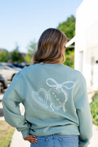 University of Alabama Seafoam Crewneck with cursive writing on the front and an open locket with the writing “Bama” inside on the back