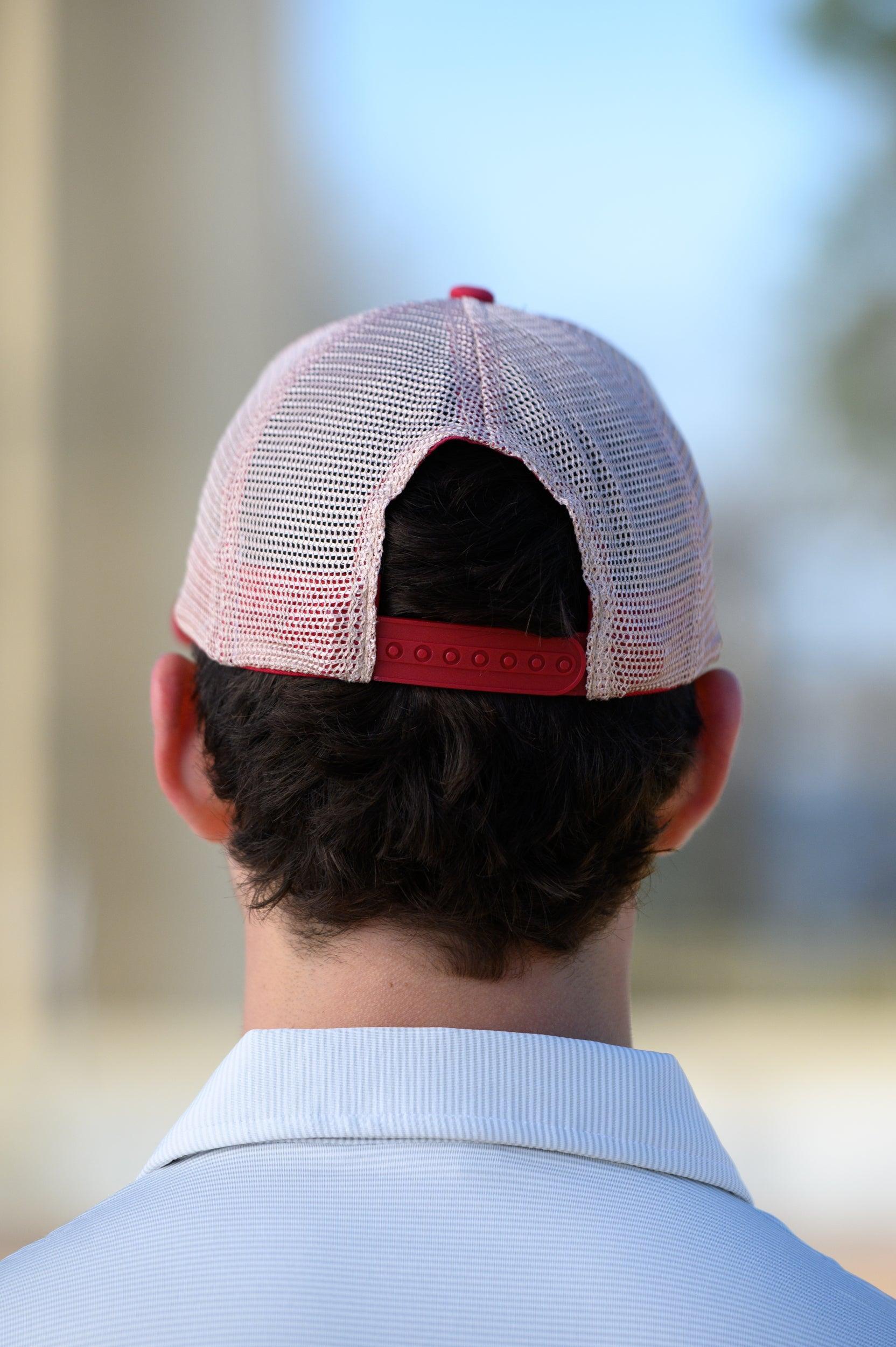University of Alabama Red Trucker Hat featuring a patch with an image of a fishing lure with Red text "Alabama." 
Snapback Trucker