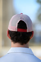 University of Alabama Red Trucker Hat featuring a patch with an image of a fishing lure with Red text "Alabama." 
Snapback Trucker