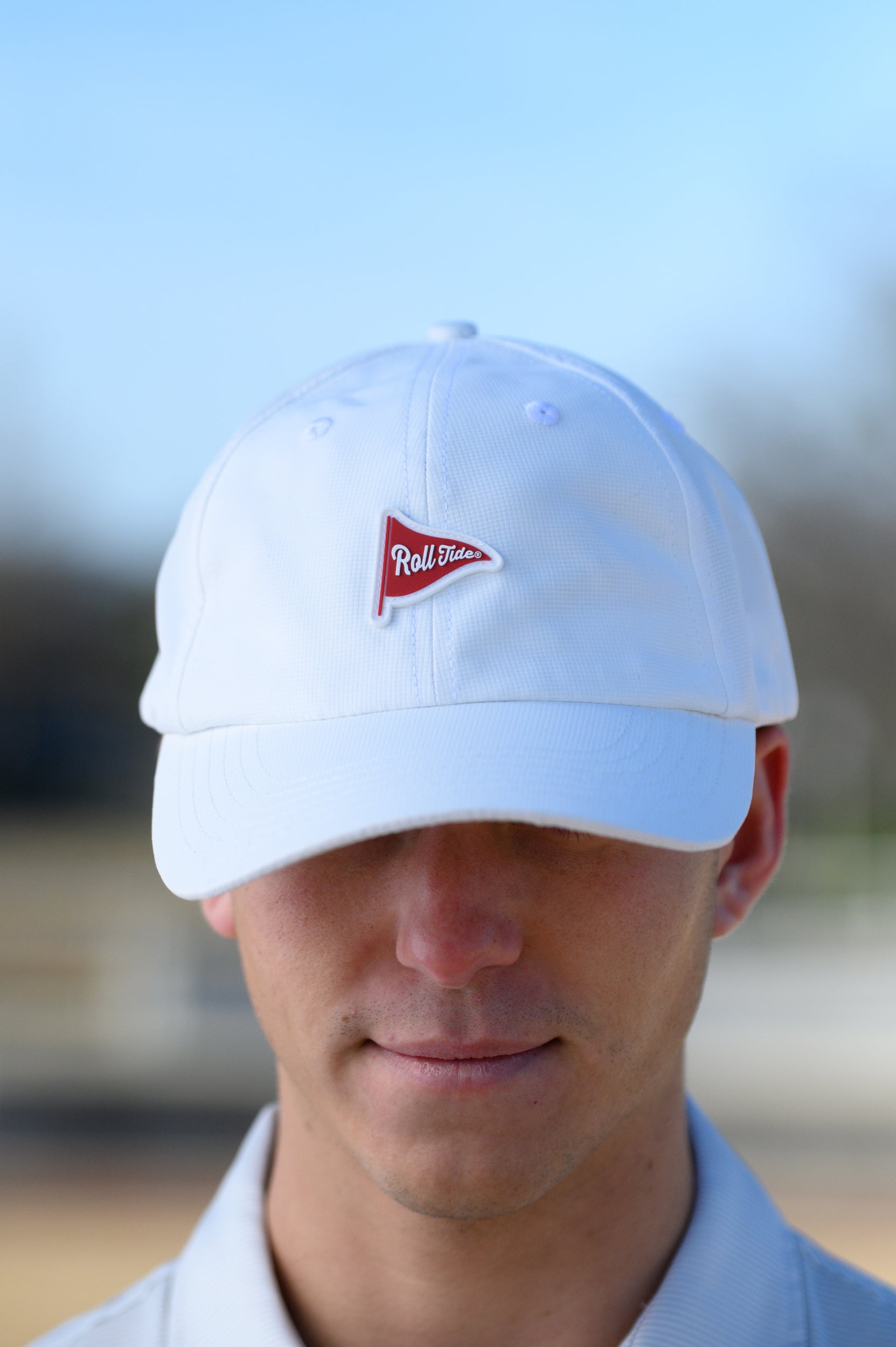 University of Alabama White Hat with a patch of a Red golf flag with White script, “Roll Tide”