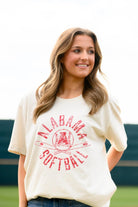 University of Alabama Distressed Ivory T-Shirt with a Red Softball featuring the Vintage A logo over crossed softball bats, surrounded by Red text “Alabama Softball”