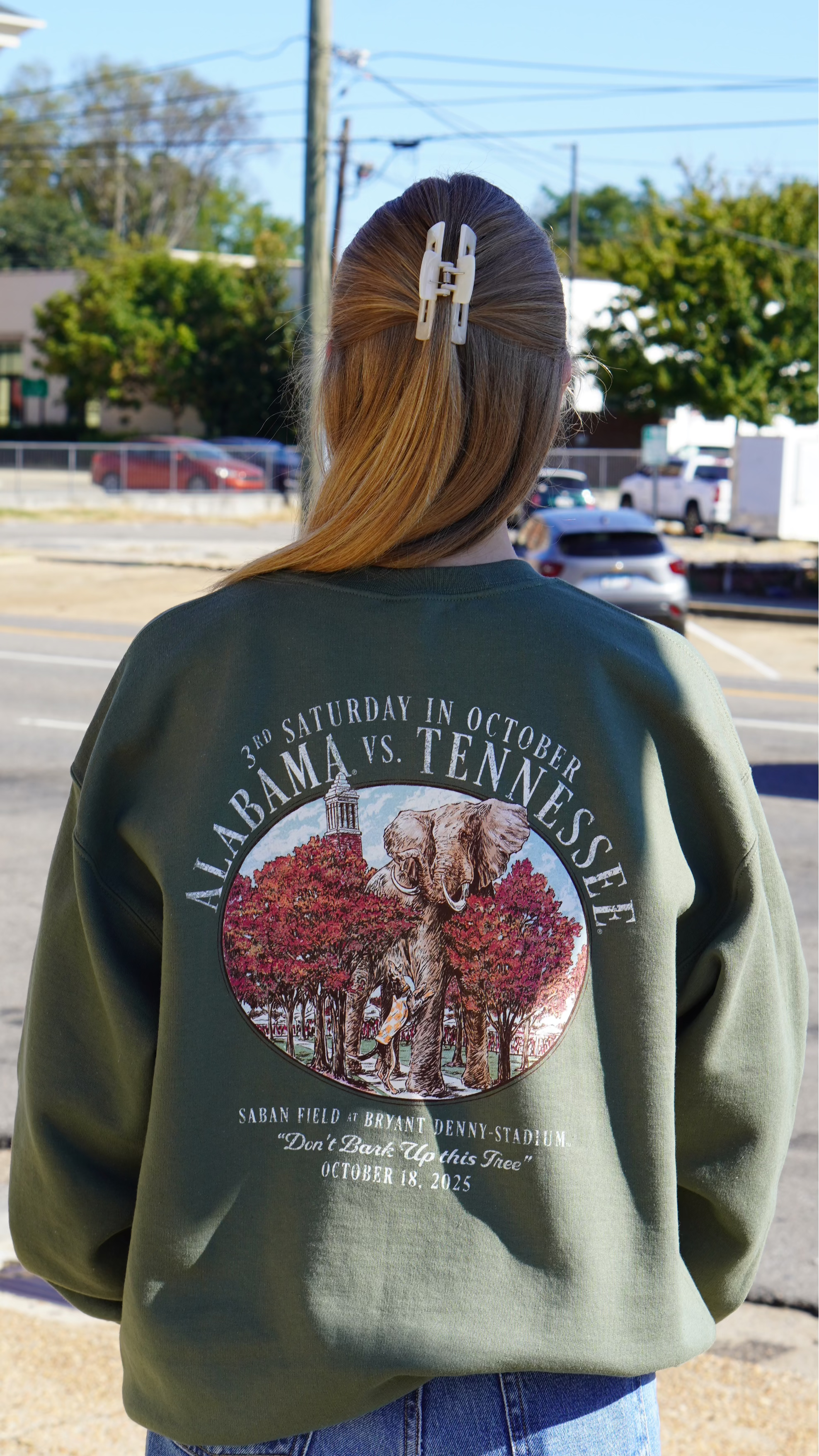 University of Alabama Army Green Sweatshirt with an illustration of an elephant smashing Tennessee memorabilia