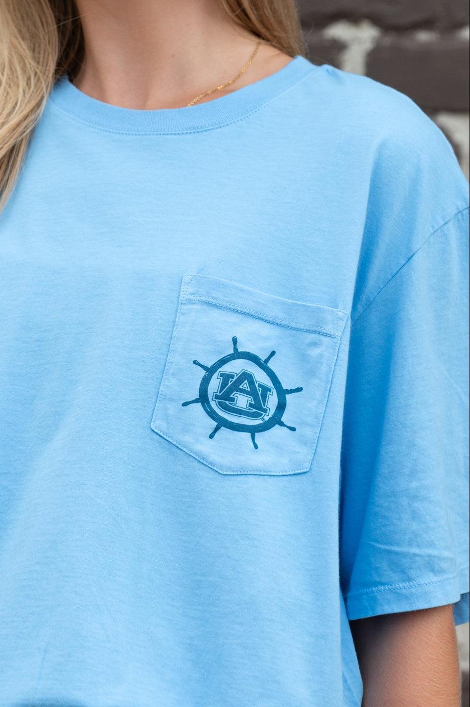 Auburn University Blue Shirt with a Front Pocket featuring a ships wheel circling the classic AU Logo