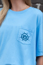 Auburn University Blue Shirt with a Front Pocket featuring a ships wheel circling the classic AU Logo