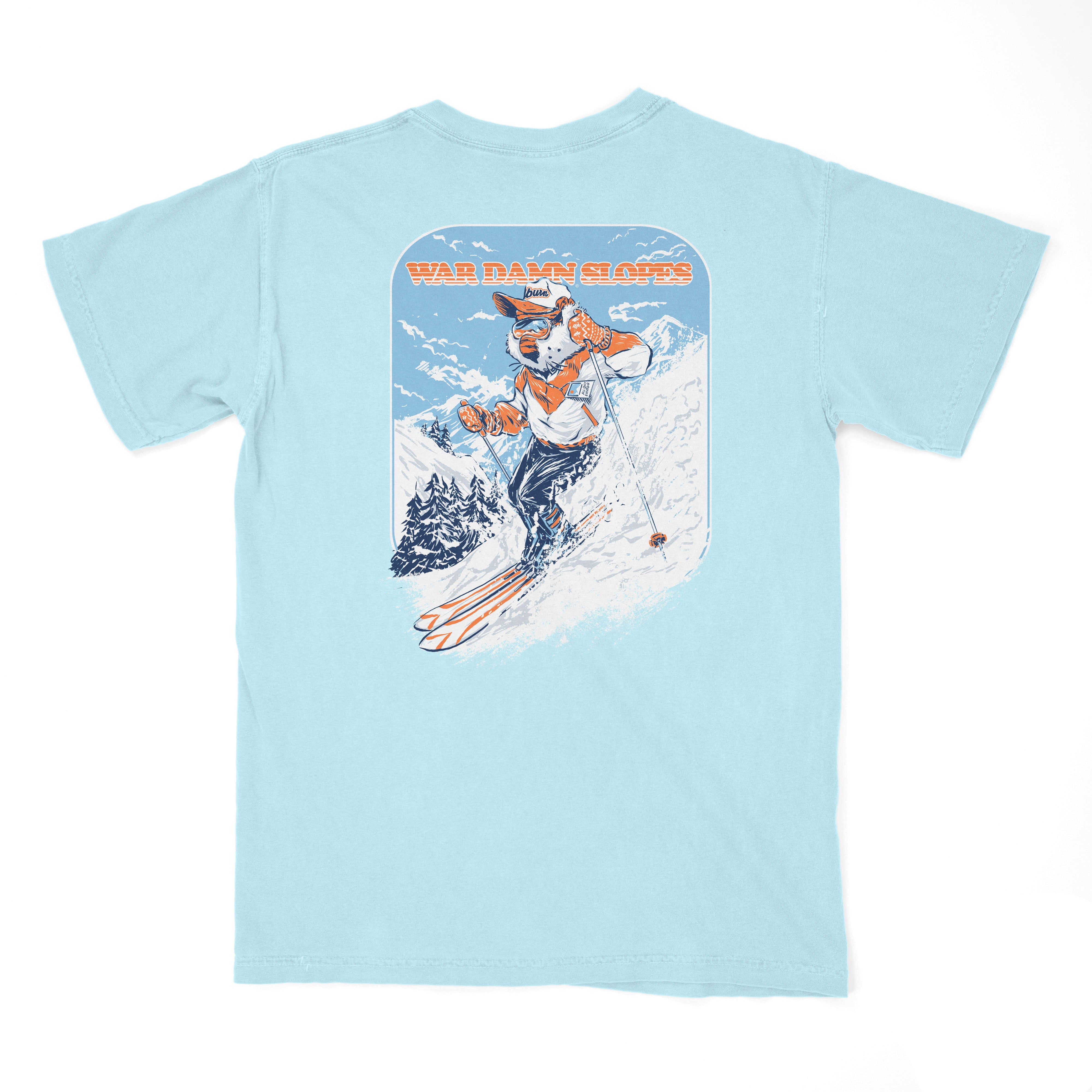 Auburn University Aubie Snow Skiing Chambray Comfort Colors T-Shirt with text "War Damn Slopes" above an image of Aubie in a ski outfit skiing down a snow-covered mountain