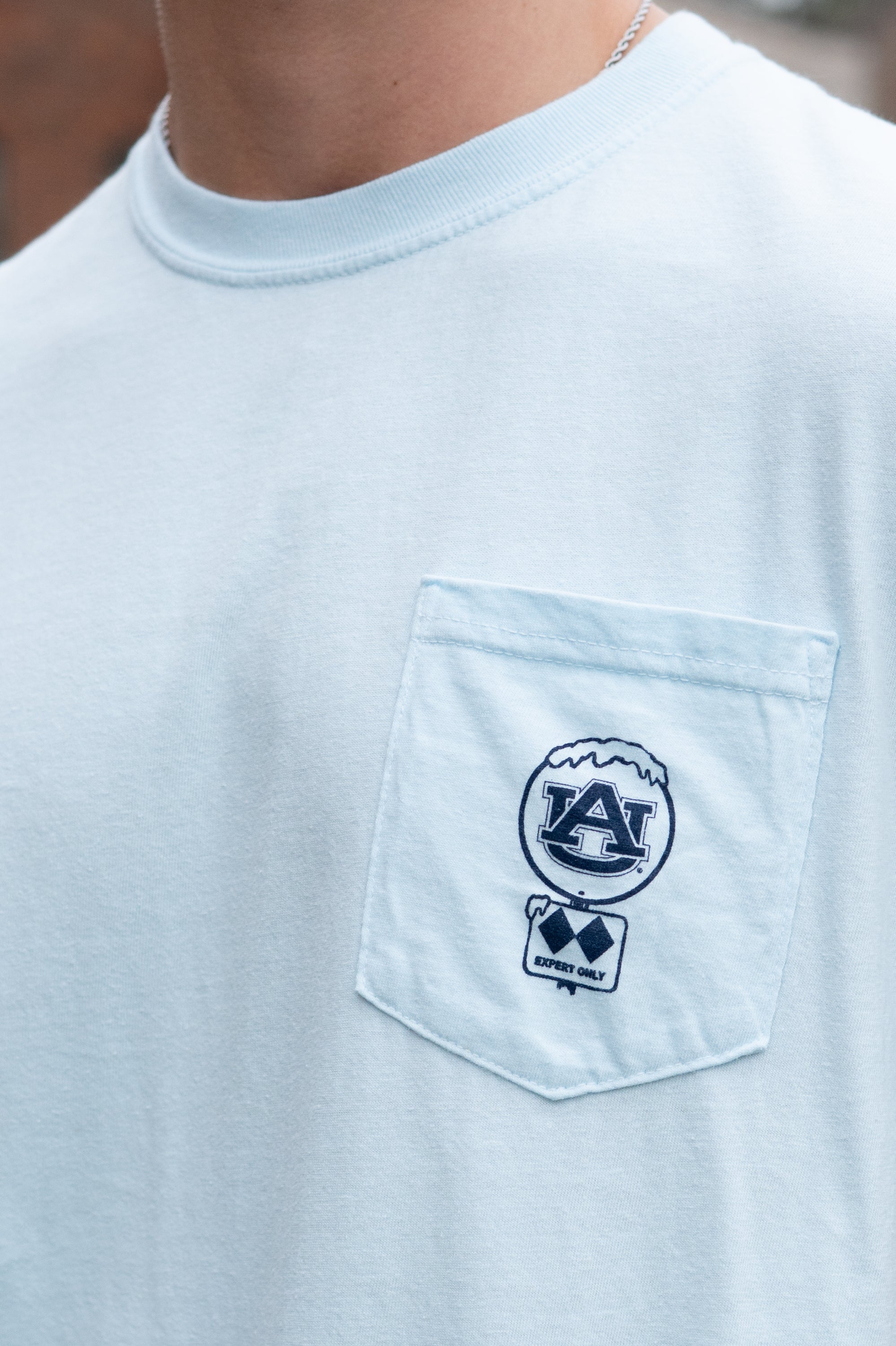 Auburn University Light Blue T-Shirt with a snow-covered Classic AU Logo on the front pocket 