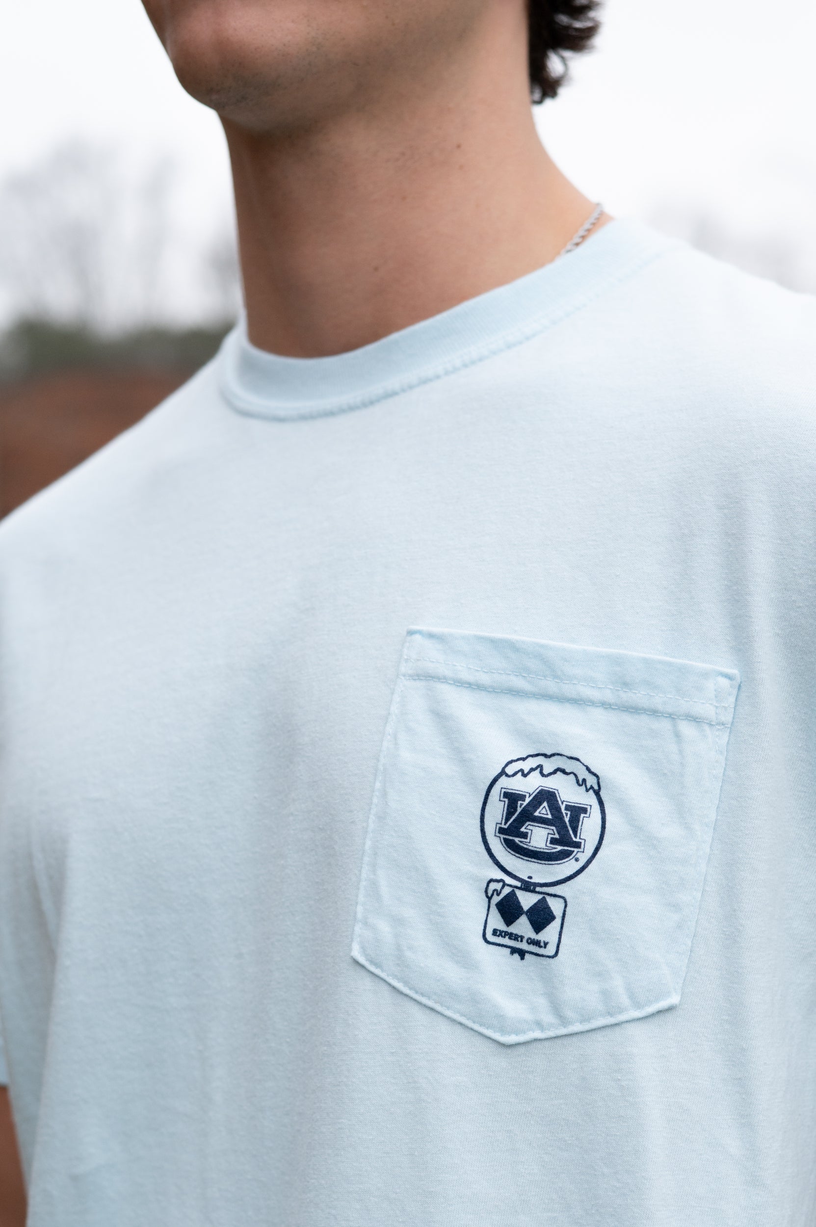 Auburn University Light Blue T-Shirt with a snow-covered Classic AU Logo on the front pocket 