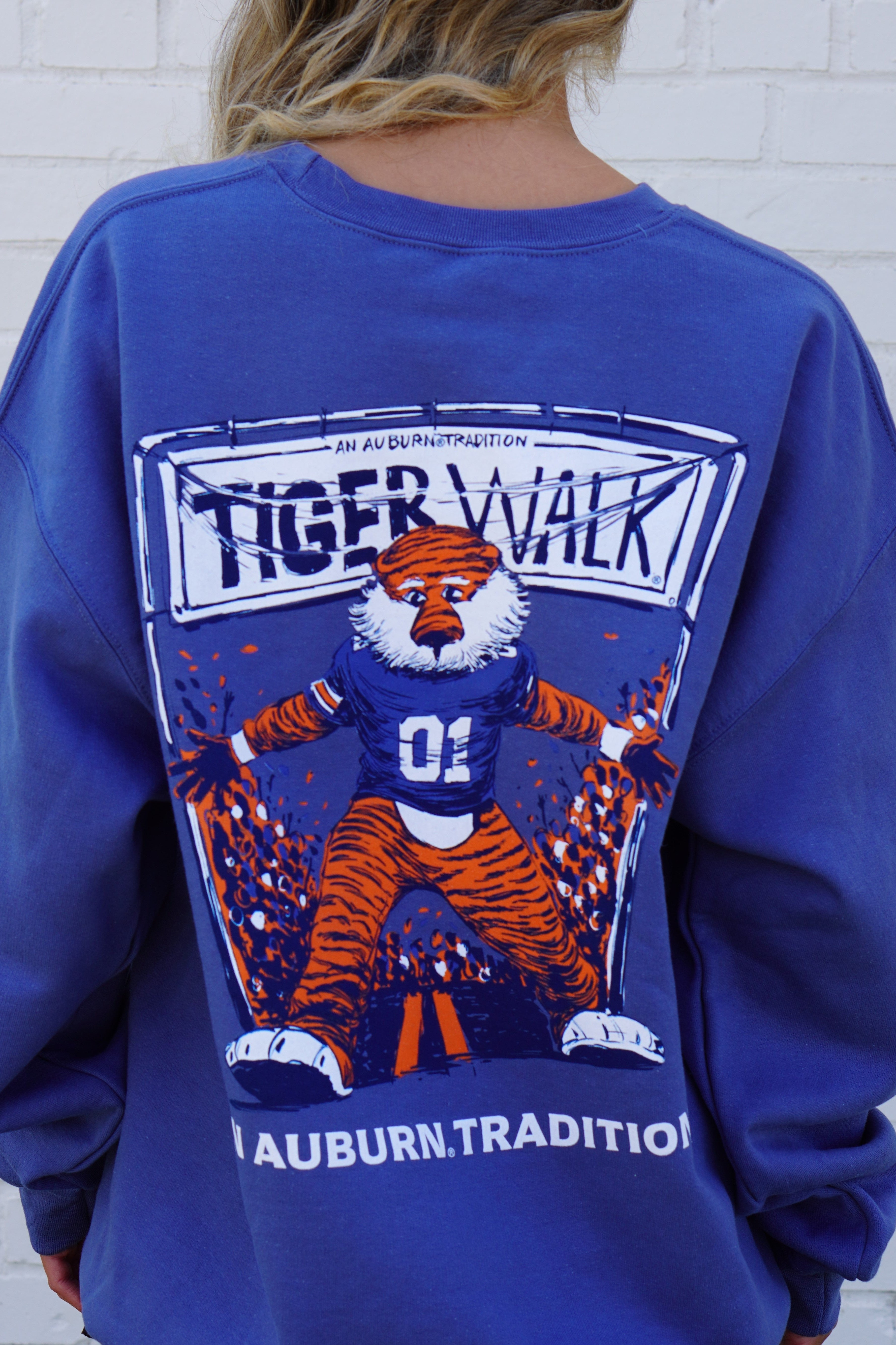Auburn University Aubie Tiger Walk Indigo Blue Gildan Sweatshirt with an image of Aubie the Tiger leading a parade under a banner with the text "Tiger Walk"