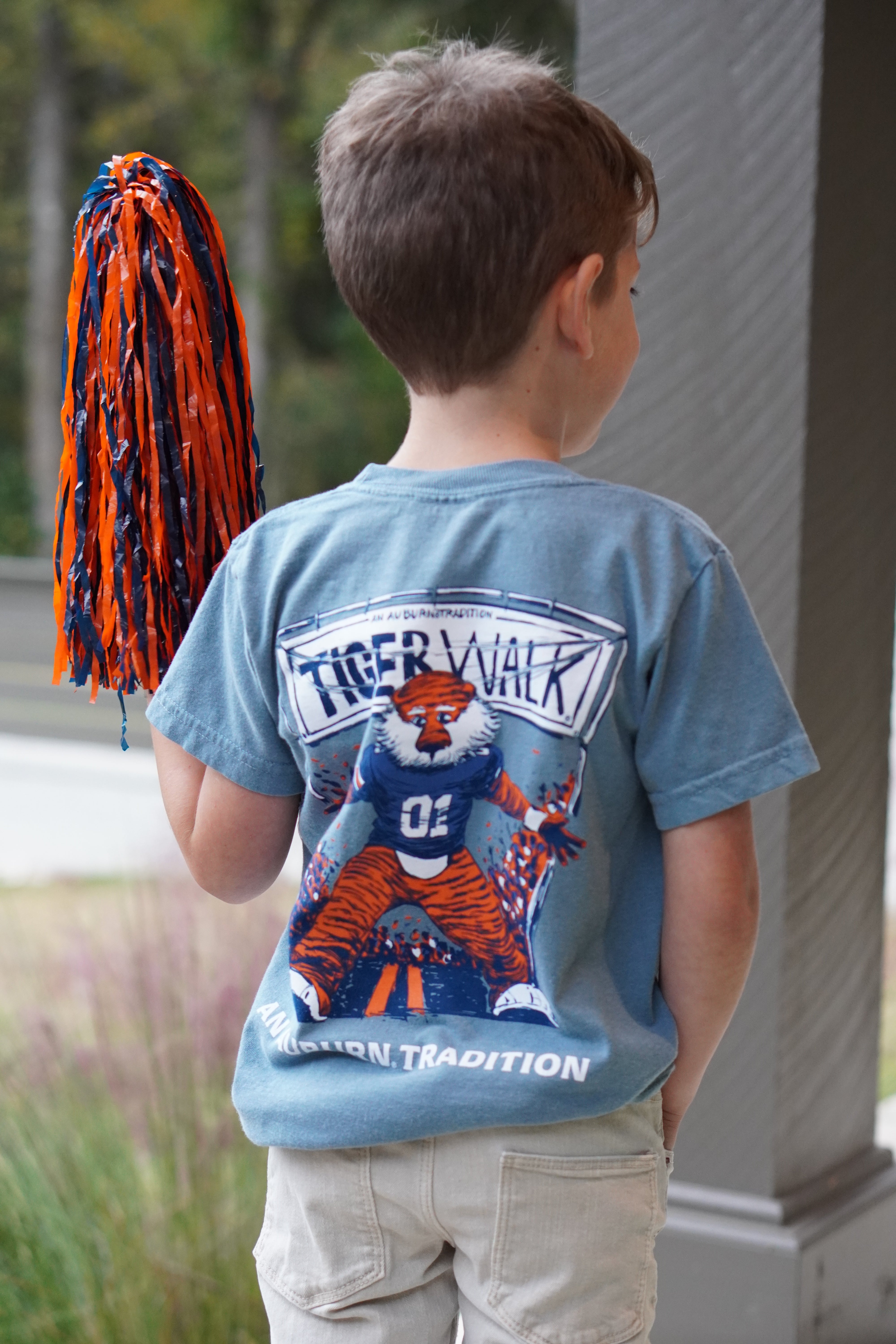 Auburn University Aubie Tiger Walk Ice Blue Gildan Youth Tee with an image of Aubie the Tiger leading a parade under a banner with the text "Tiger Walk"