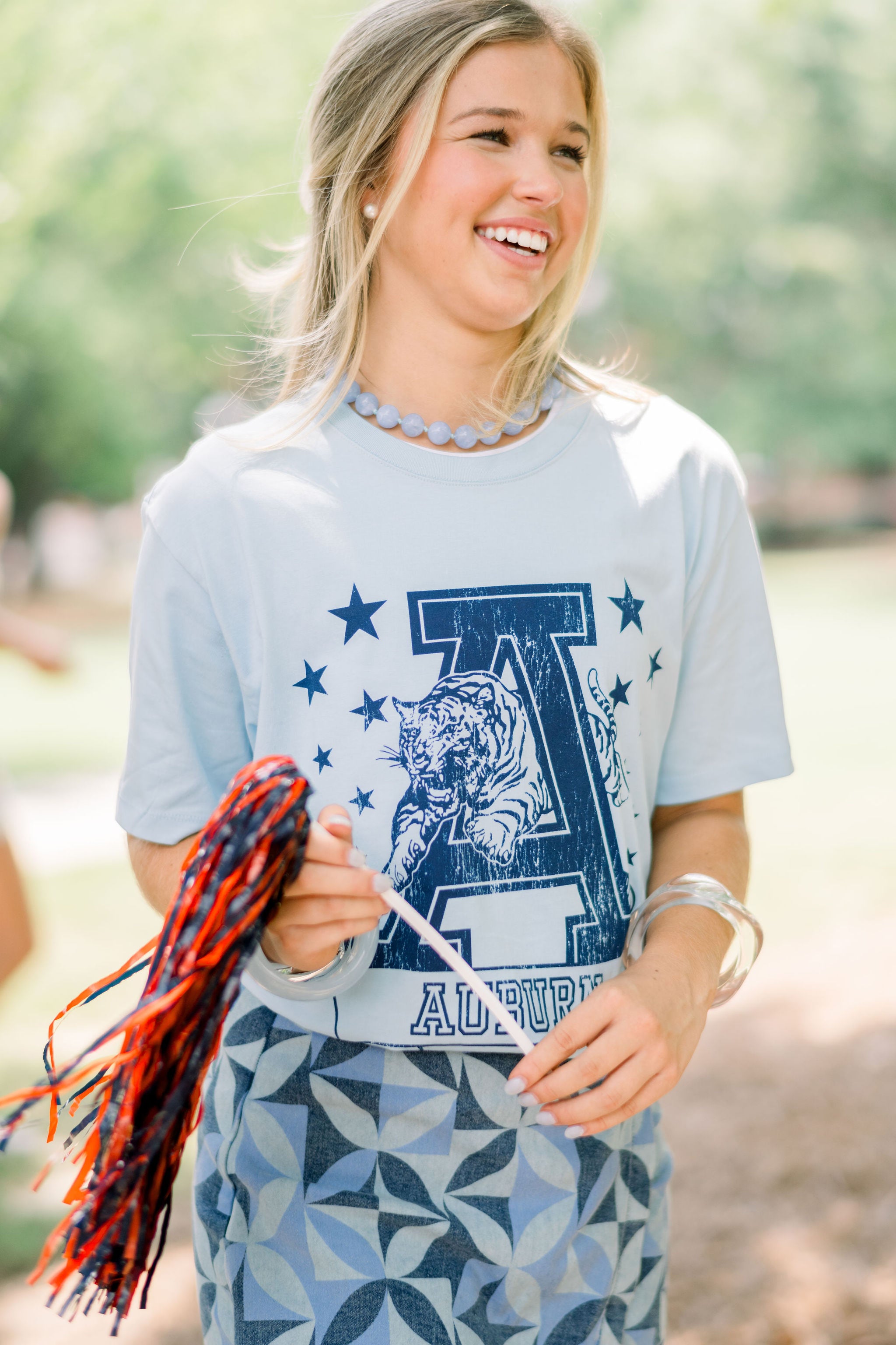 Auburn University Light Blue T-Shirt with Navy stars surrounding a Navy Leaping Tiger Logo