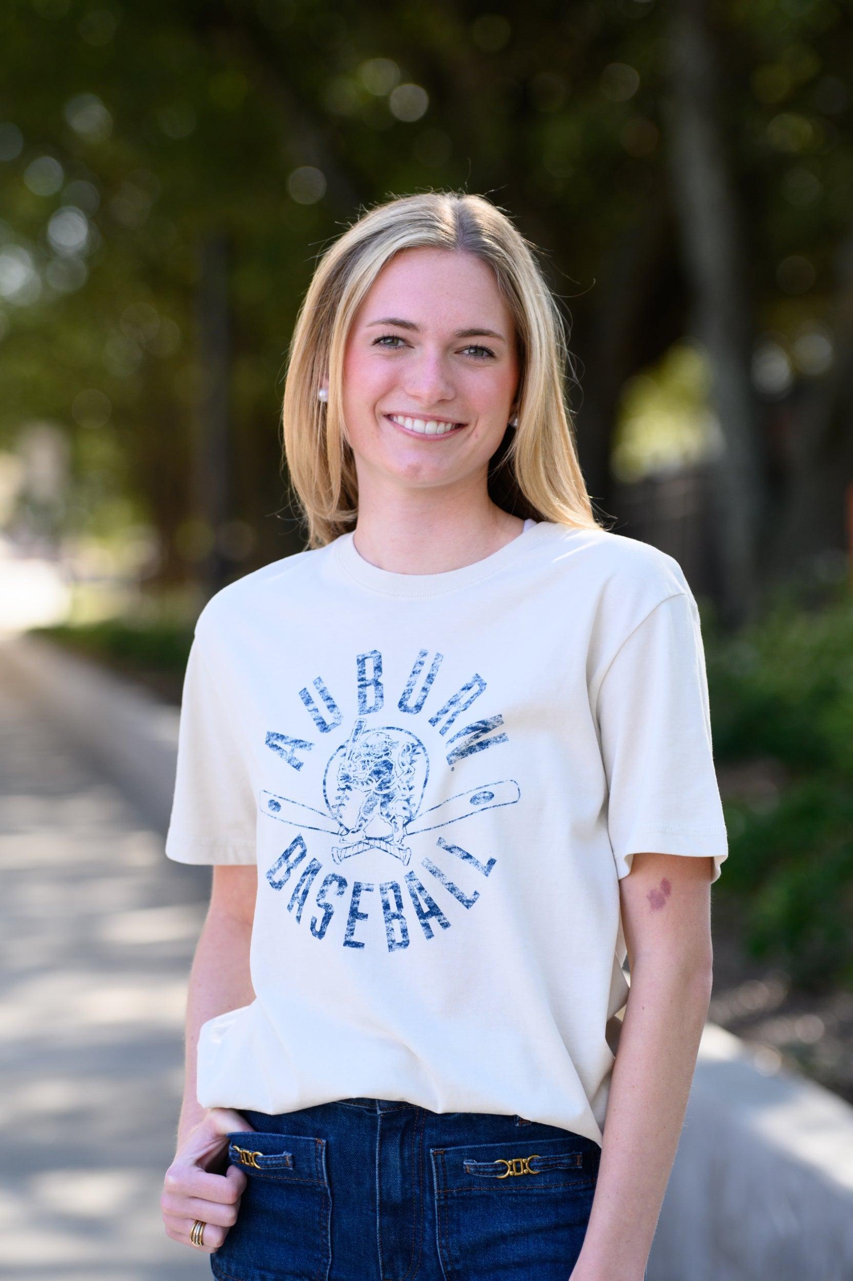Auburn University Distressed Ivory with a Blue Baseball featuring the Original Aubie Baseball logo over crossed baseball bats, surrounded by Blue text “Auburn Baseball”