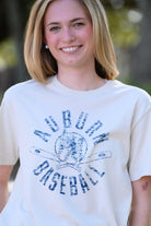 Auburn University Distressed Ivory with a Blue Baseball featuring the Original Aubie Baseball logo over crossed baseball bats, surrounded by Blue text “Auburn Baseball”