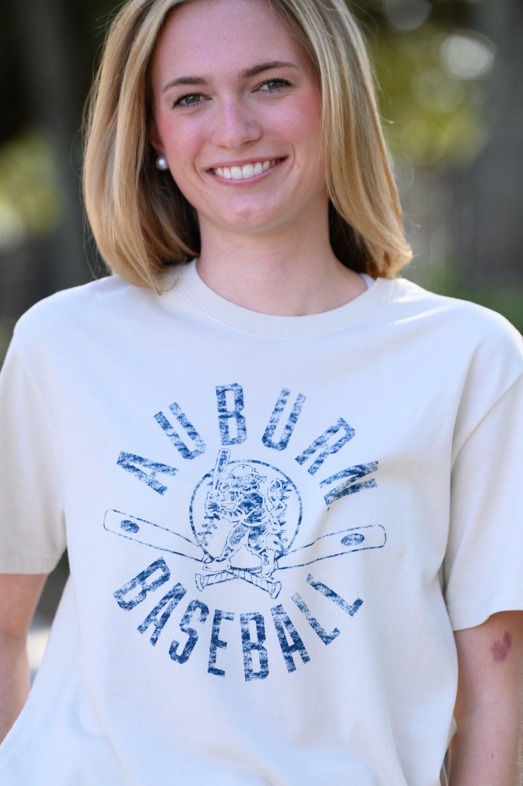 Auburn University Distressed Ivory with a Blue Baseball featuring the Original Aubie Baseball logo over crossed baseball bats, surrounded by Blue text “Auburn Baseball”