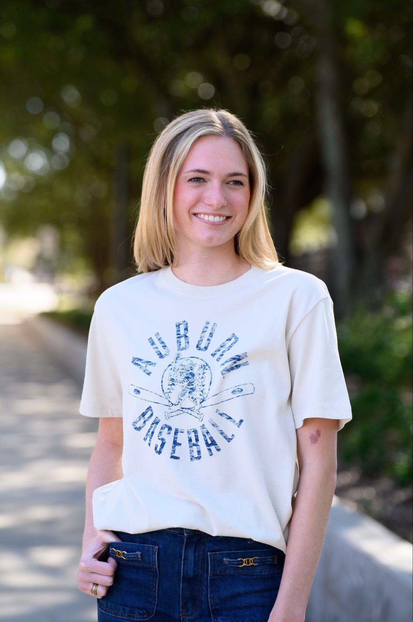 Auburn University Distressed Ivory with a Blue Baseball featuring the Original Aubie Baseball logo over crossed baseball bats, surrounded by Blue text “Auburn Baseball”