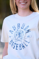 Auburn University Distressed Ivory with a Blue Baseball featuring the Original Aubie Baseball logo over crossed baseball bats, surrounded by Blue text “Auburn Baseball”