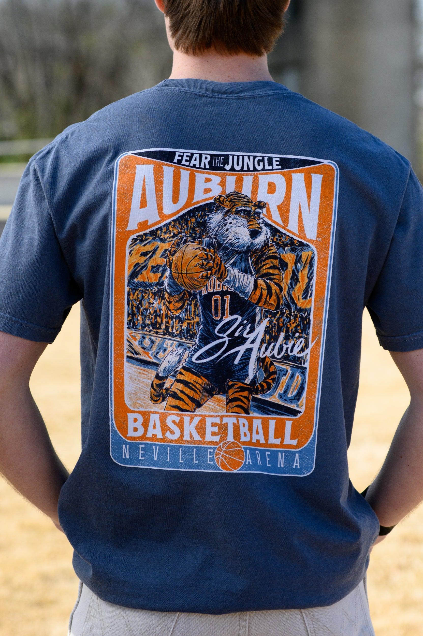 Auburn University Dark Blue T-Shirt with a basketball card style design featuring Aubie dribbling a basketball down the court in between text “Fear the Jungle Auburn” and “Basketball Neville Arena” and with an autograph from “Sir Aubie”
