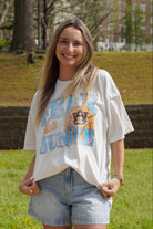 Auburn University Off-White T-Shirt with 'FEAR THE JUNGLE' text, a basketball with the AU Logo and tiger claw marks design