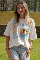 Auburn University Off-White T-Shirt with 'FEAR THE JUNGLE' text, a basketball with the AU Logo and tiger claw marks design