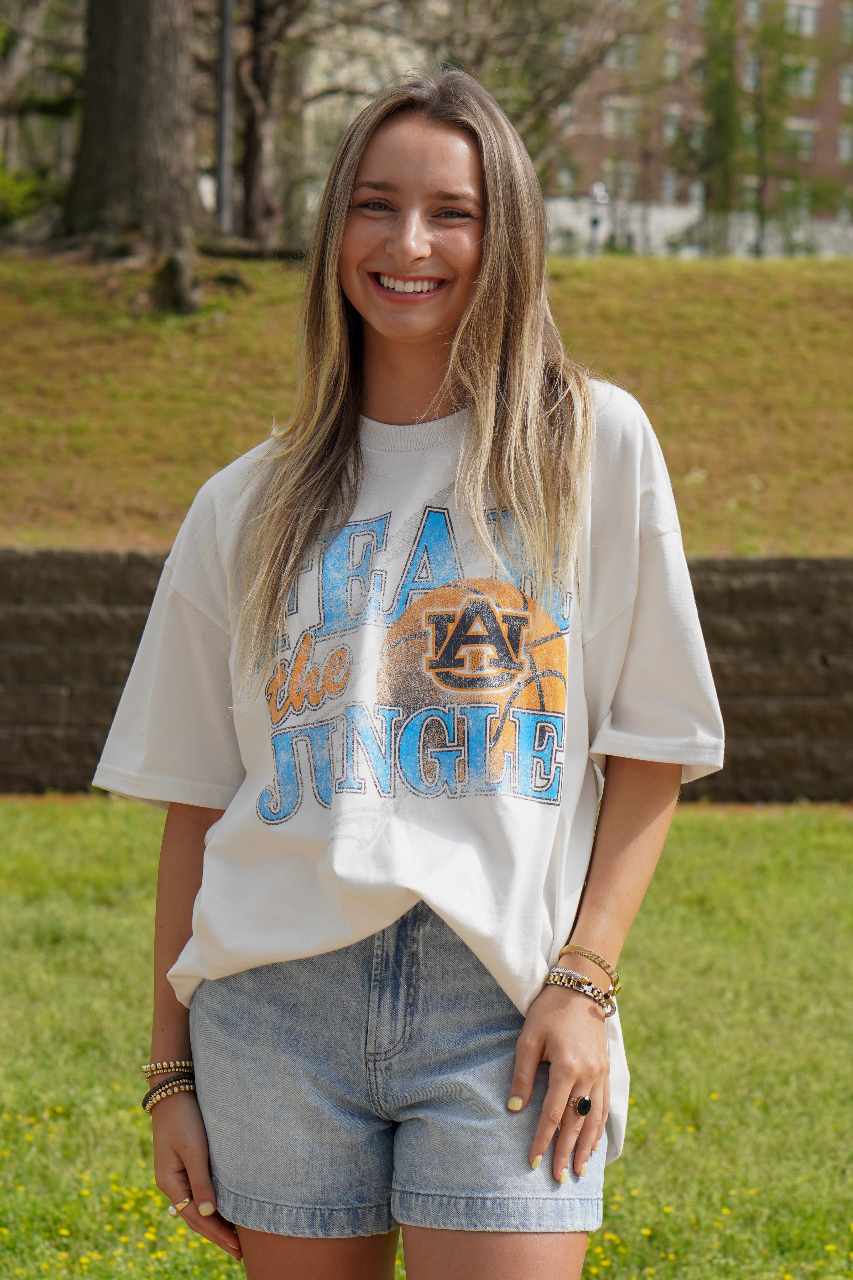 Auburn University Off-White T-Shirt with 'FEAR THE JUNGLE' text, a basketball with the AU Logo and tiger claw marks design