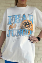 Auburn University Off-White T-Shirt with 'FEAR THE JUNGLE' text, a basketball with the AU Logo and tiger claw marks design