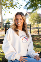 Auburn University Cream Sweatshirt with Navy text “Auburn Family” above the state flag and American flag crossed under the Block Auburn A 