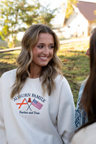 Auburn University Cream Sweatshirt with Navy text “Auburn Family” above the state flag and American flag crossed under the Block Auburn A 