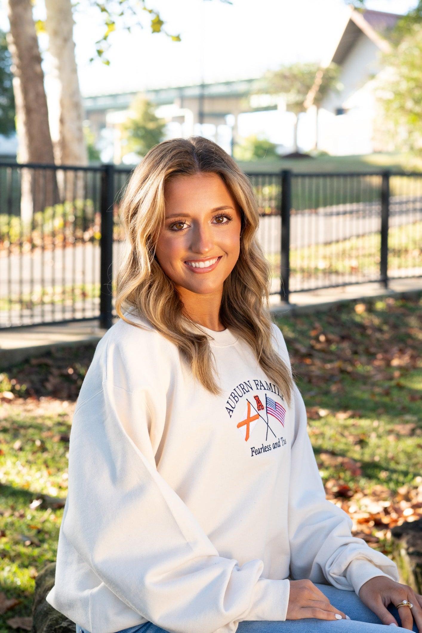 Auburn University Cream Sweatshirt with Navy text “Auburn Family” above the state flag and American flag crossed under the Block Auburn A 