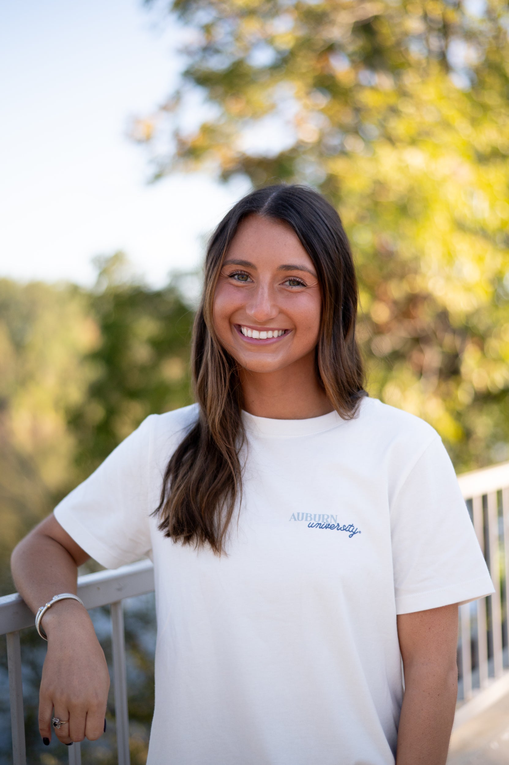 Auburn University White Ladies Tee with a vintage Blue illustration of cowgirl boots with bows tied on them above Blue text “Home On The Plains”