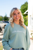 Auburn University Seafoam Crewneck with cursive writing on the front and an open locket with the writing “WDE” inside on the back