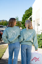 Auburn University Seafoam Crewneck with cursive writing on the front and an open locket with the writing “WDE” inside on the back