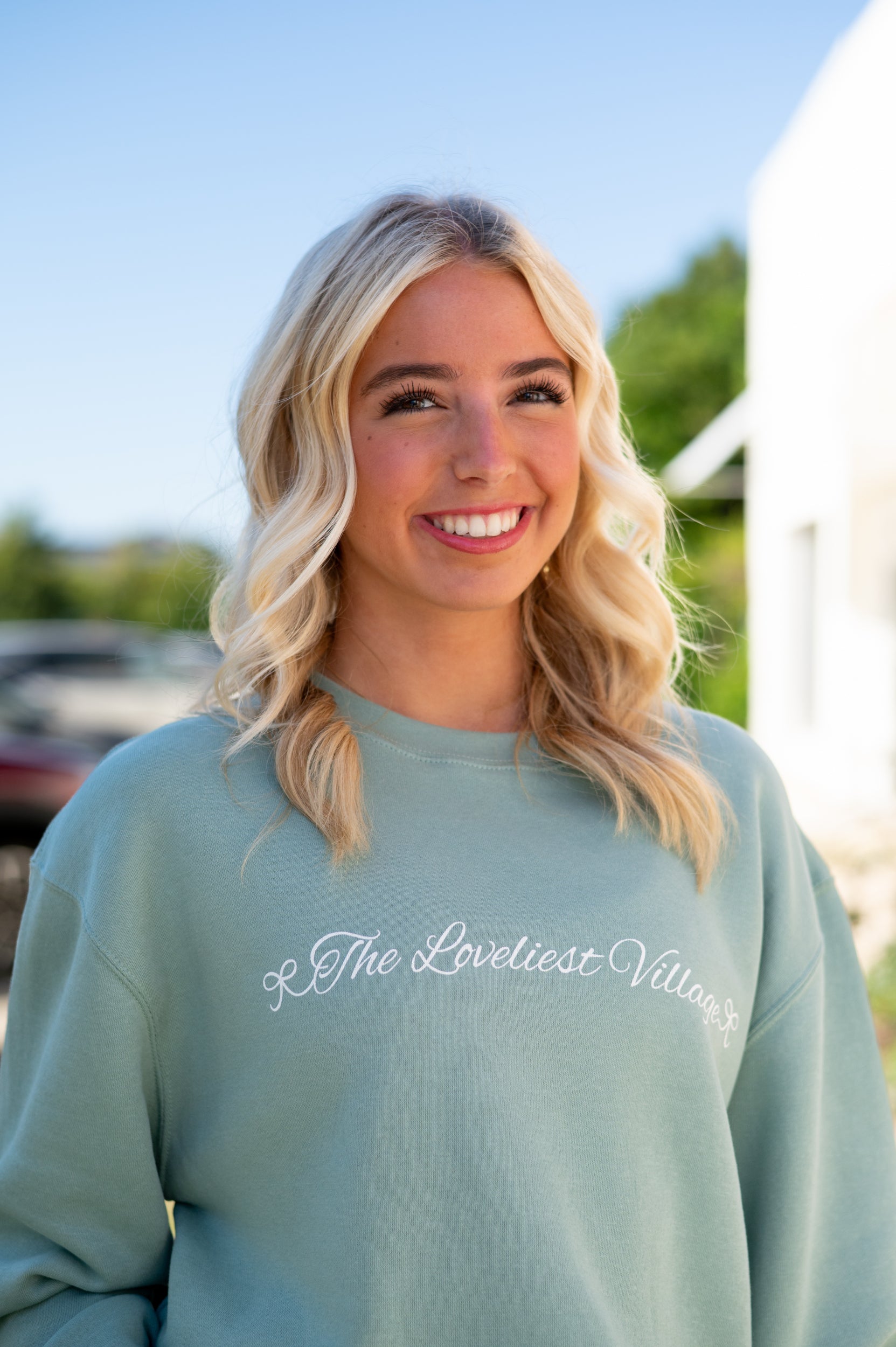Auburn University Seafoam Crewneck with cursive writing on the front and an open locket with the writing “WDE” inside on the back