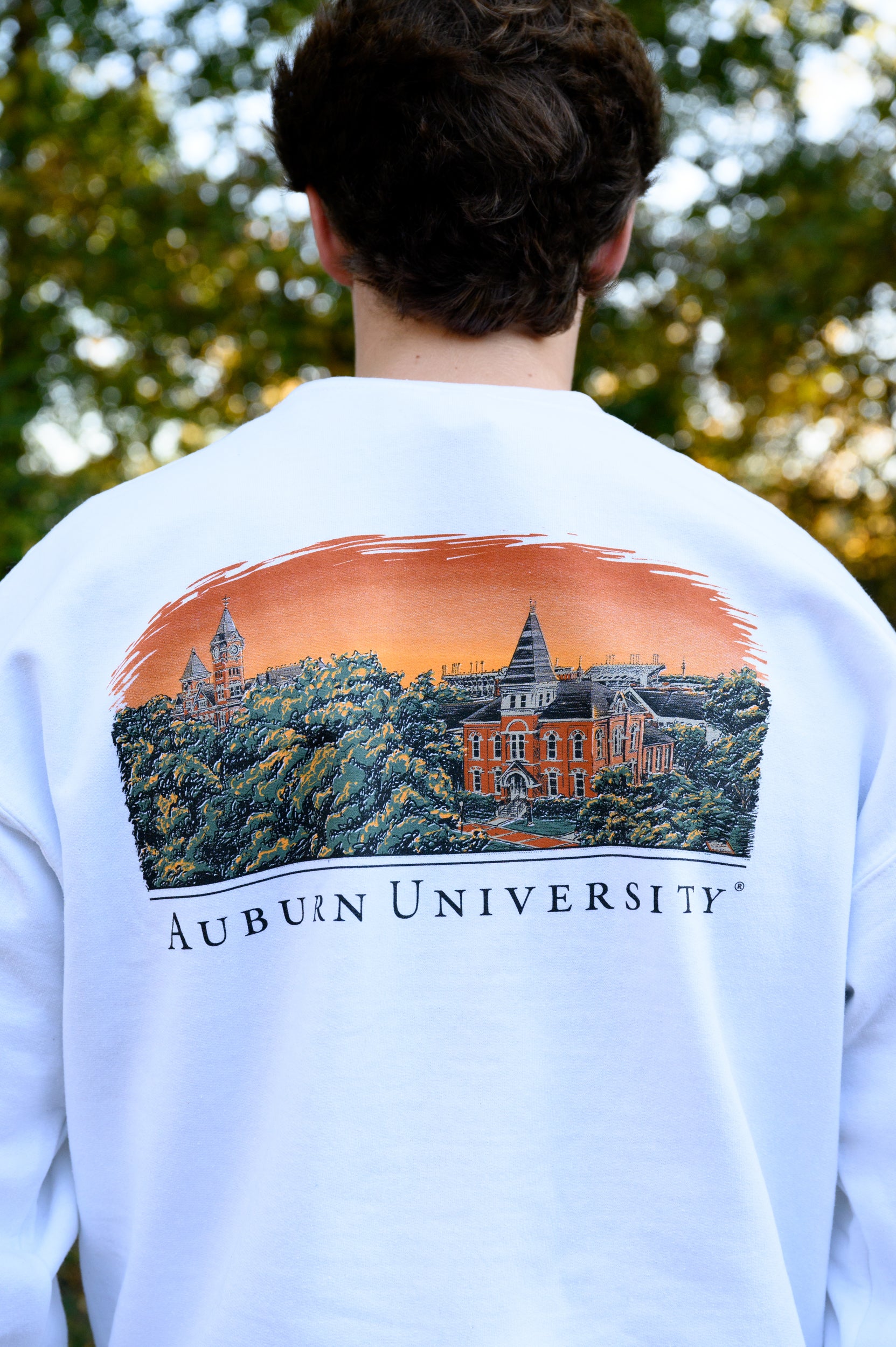 Auburn University Auburn Skyline  White Gildan Sweatshirt with an image of a sun setting on the University above text "Auburn University"
