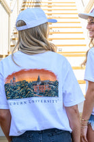 Auburn University Auburn Skyline White Comfort Colors T-Shirt with an image of a sun setting on the University above text "Auburn University"