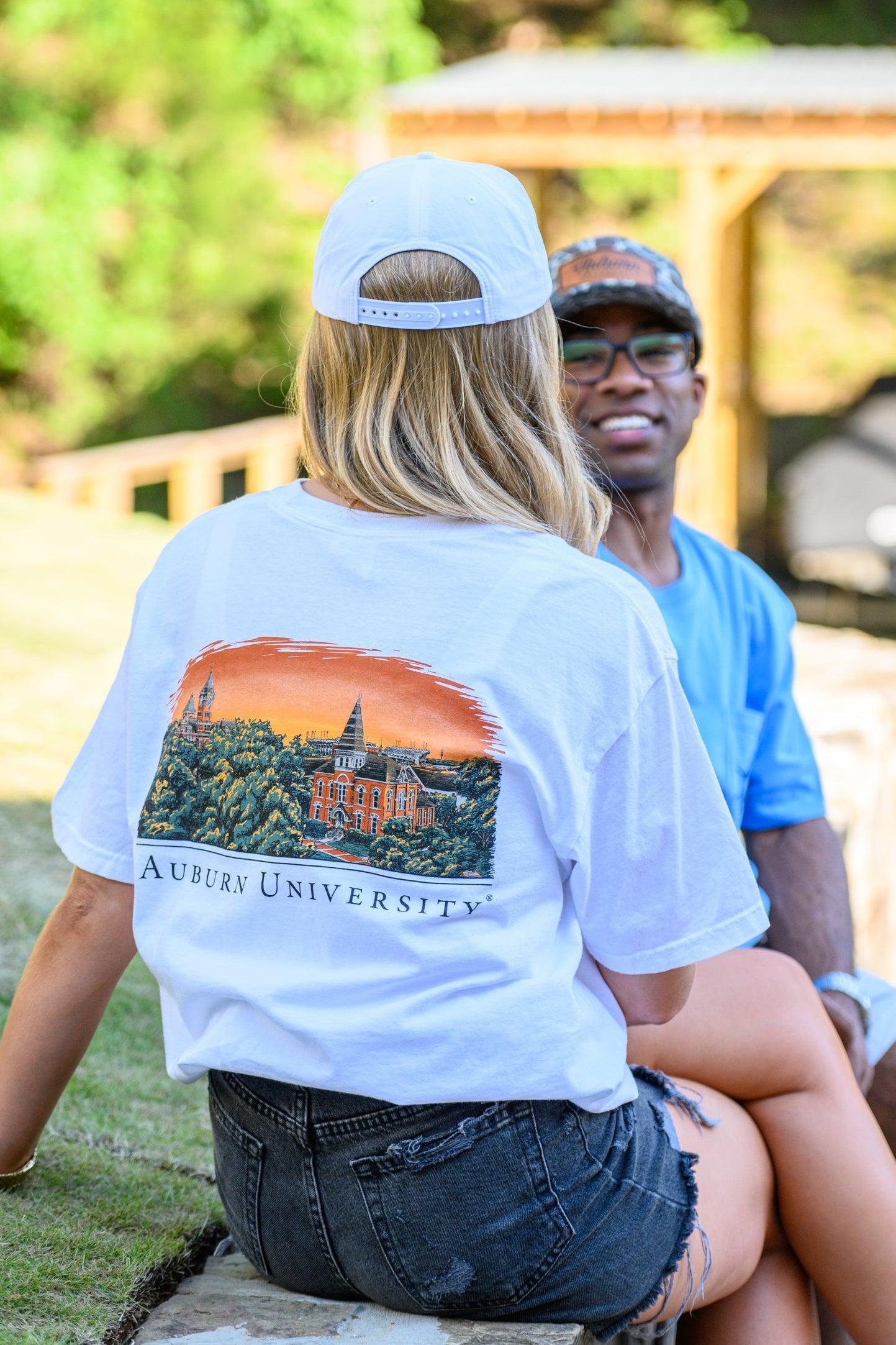 Auburn University Auburn Skyline White Comfort Colors T-Shirt with an image of a sun setting on the University above text "Auburn University"