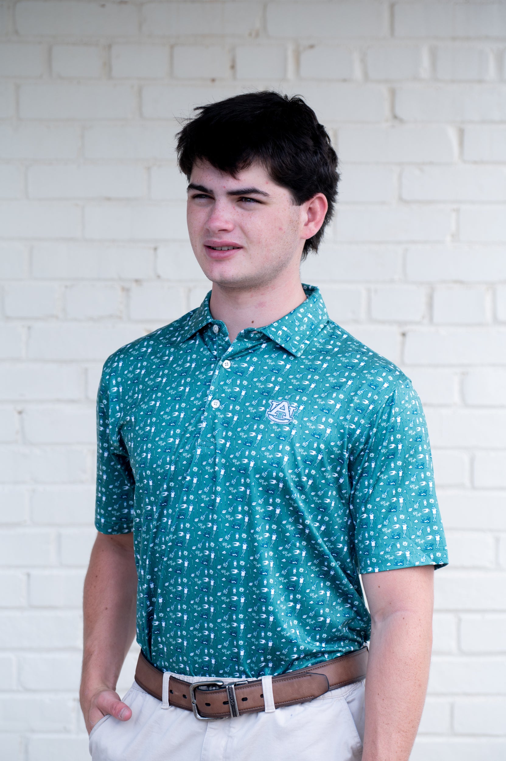 Auburn University Green Men’s Polo with an Auburn golf-themed pattern and Silver AU Logo embroidery