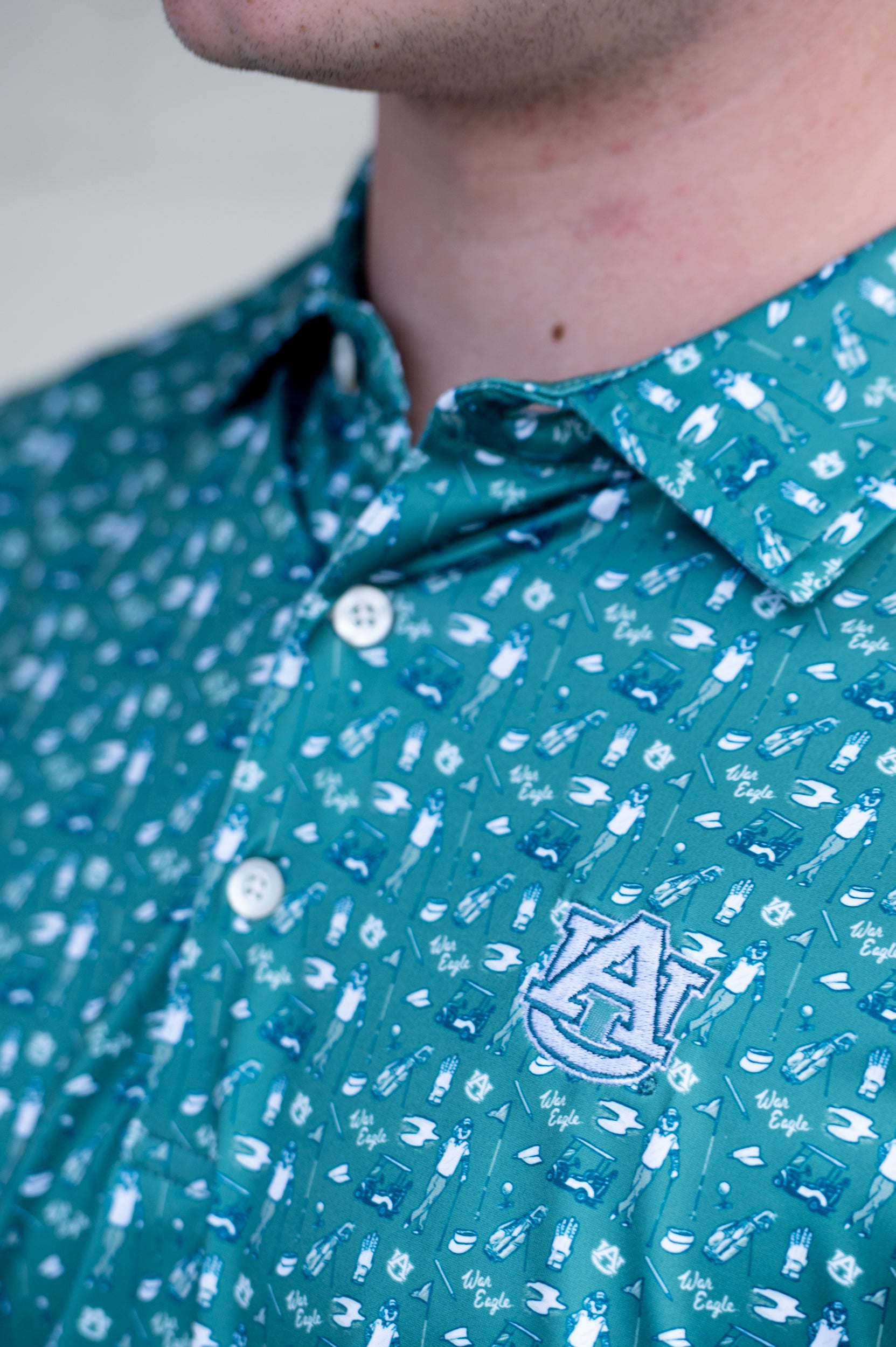 Auburn University Green Men’s Polo with an Auburn golf-themed pattern and Silver AU Logo embroidery
